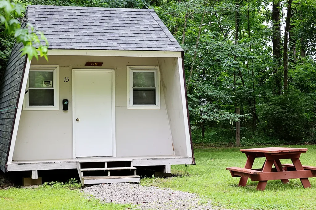 Elm cabin exterior, A-frame cottage with picnic table