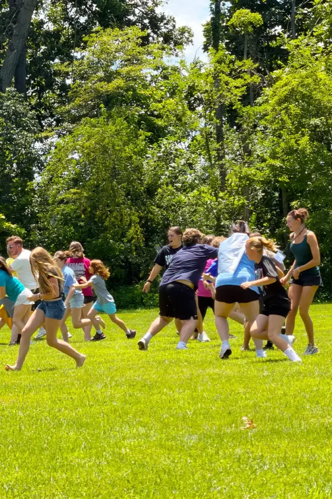 Campers playing a group game on the grass field