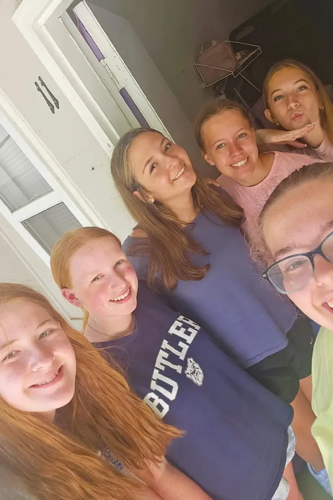 Group of girls taking a selfie on a cabin porch