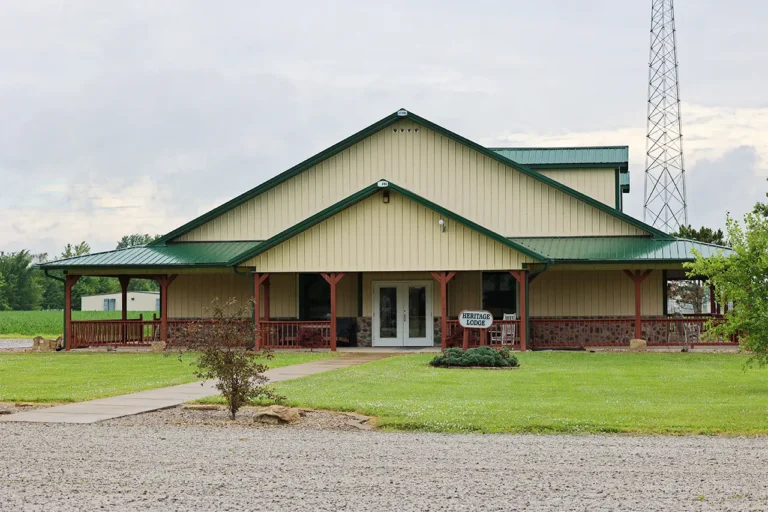 Heritage Lodge exterior with wraparound porch and green roof