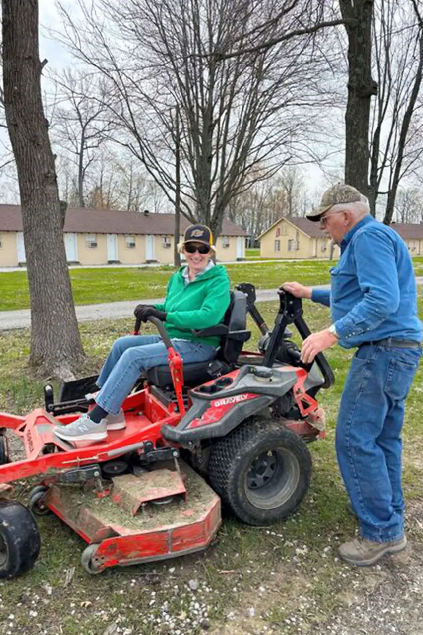 Two volunteers working on the camp grounds
