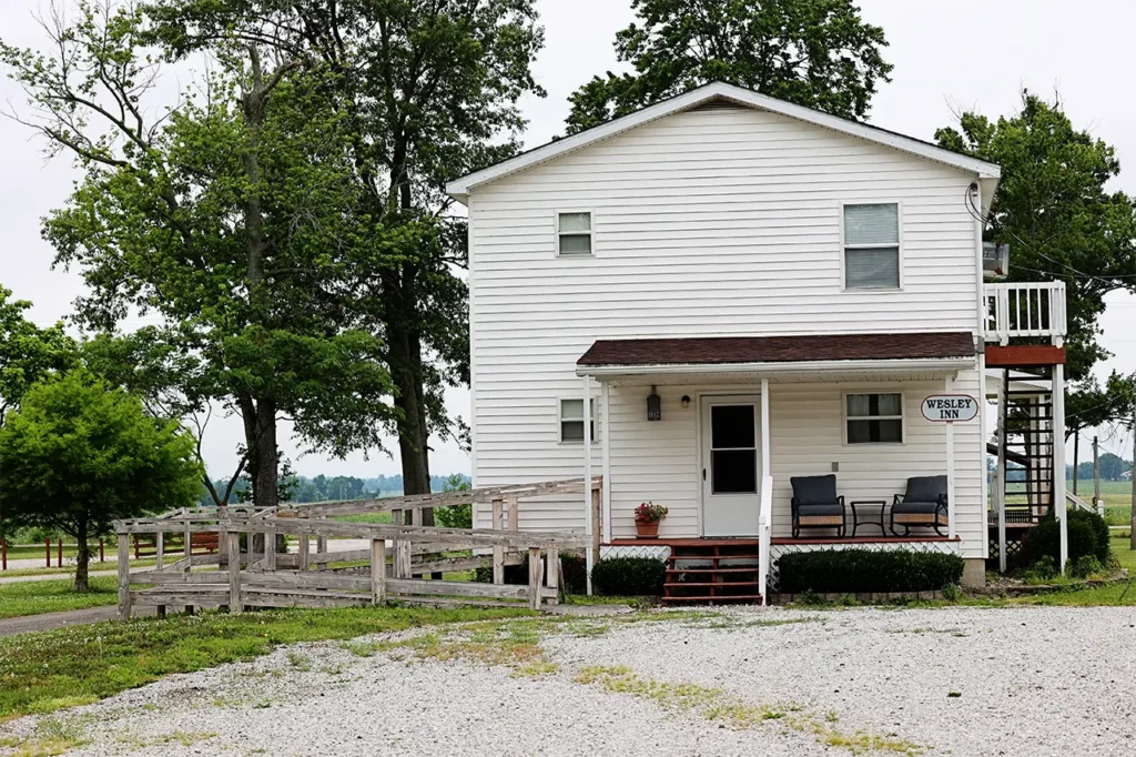 Wesley Inn exterior, two-story white house with front porch