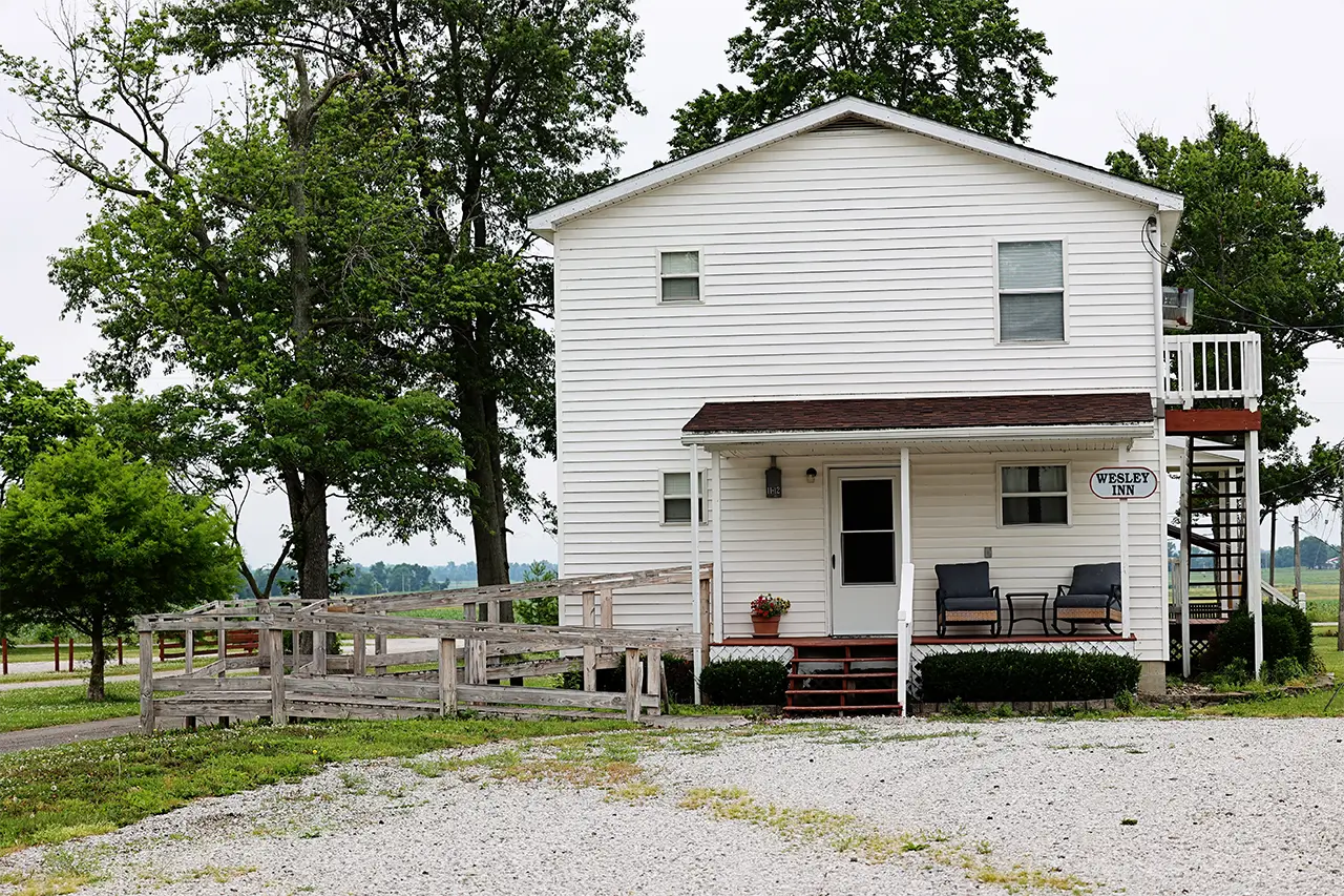 Wesley Inn exterior, two-story white house with front porch